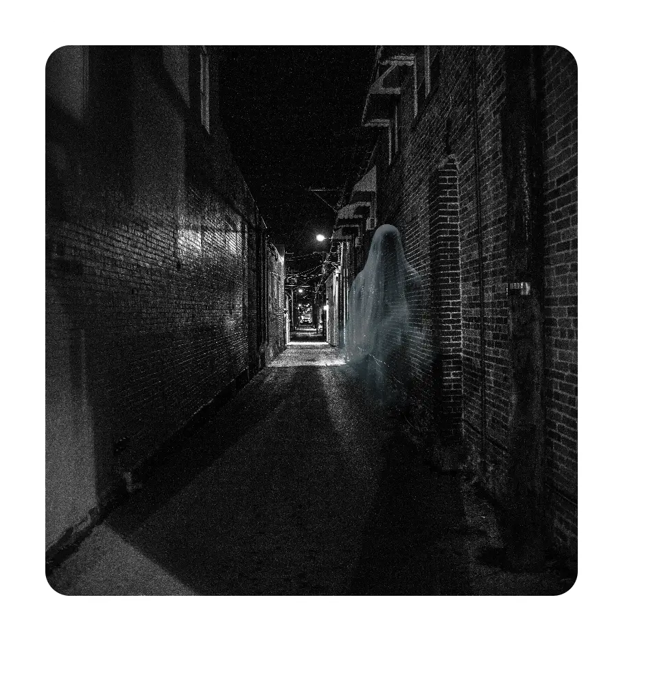 A spectral figure haunts the shadowed alley