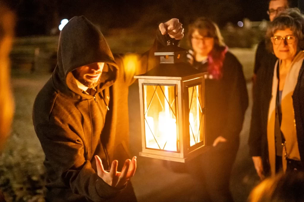 A tour guide holding a lantern