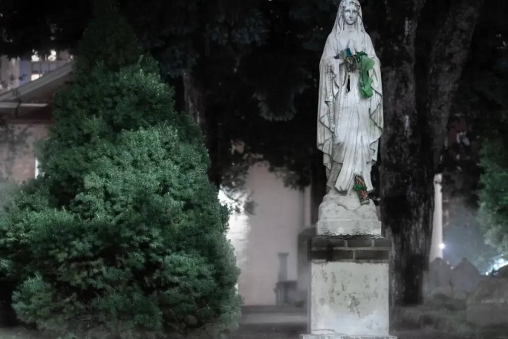 A statue of Mary in a cemetery