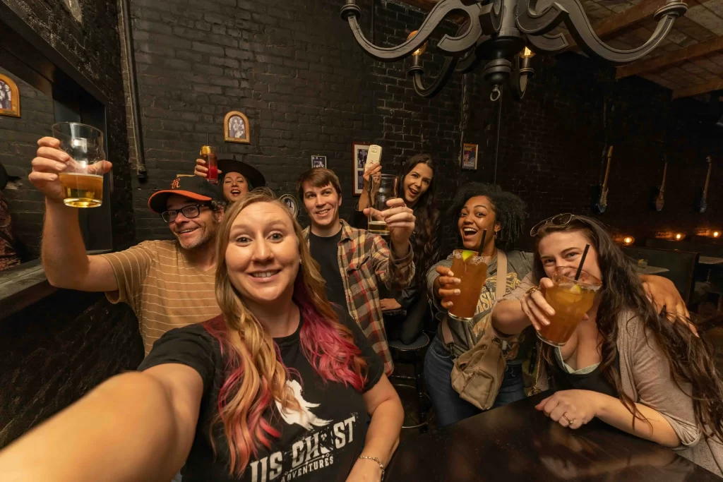 Group enjoying drinks on a haunted pub crawl night out